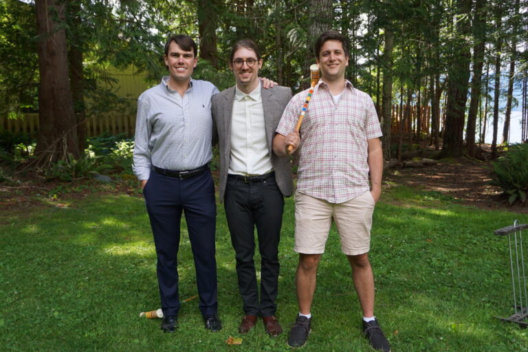 Nathan Smith, Adam Bernberg and Dealer Lux CTO Dylan Tomlinson standing together outdoors.